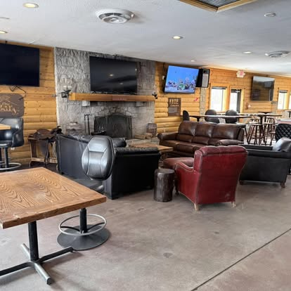 Stone fireplace lounge with leather couches