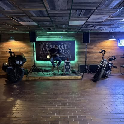 Live music stage flanked by motorcycles